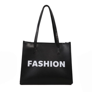 Minimalist black leather tote bag with white FASHION print and long shoulder straps
