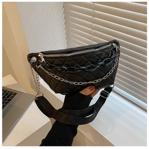 Detail of black quilted waist bag featuring double chain decor and nylon strap