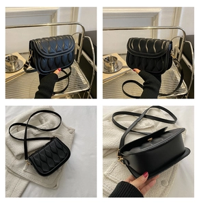 Detail of leaf-quilted texture and gold-tone hardware on this black crossbody bag
