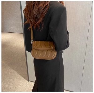 Brown faux leather crossbody bag with wave quilted texture and gold metal buckle