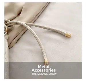 Detail view of cream leather drawstring with premium gold cylindrical metal hardware