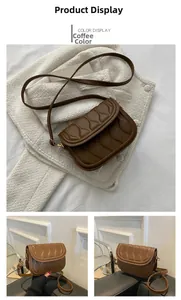 Detail of brown vintage crossbody bag with wave quilted texture and slim shoulder strap