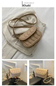 Detail of khaki saddle bag with wave quilted texture and gold metal buckle hardware