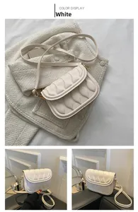 Detail of white quilted crossbody bag with wave texture and adjustable shoulder strap