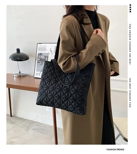 Close-up of black quilted tote bag with diamond stitching and large capacity design