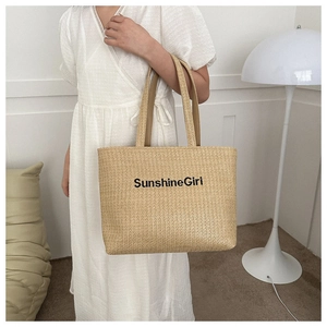 Close-up of woven canvas tote bag featuring SunshineGirl embroidery and large capacity
