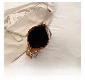 Top view showing the large internal capacity of the tan rhinestone bag with silver chain