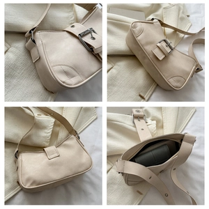 Detail view of cream matte shoulder bag showing silver buckle and internal capacity