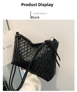 Detail of black quilted bucket bag with glossy finish and gold adjustment buckle hardware