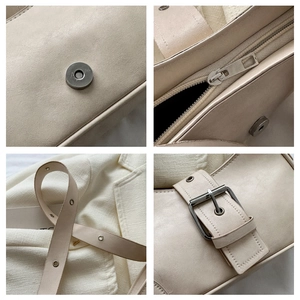 Detail view of cream chain bag featuring magnetic snap, silver zipper and leather texture