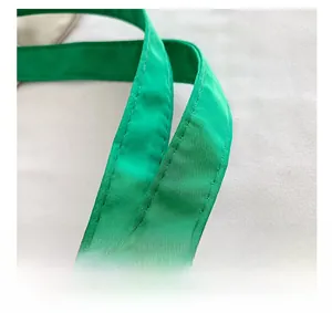 Close-up of bright green nylon tote handle with durable double-stitch craft details