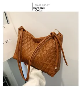 Detailed macro view of caramel quilted faux leather texture with sleek golden ring accents