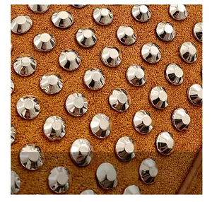 Detailed macro shot of brown suede texture and silver metallic rivets on a shoulder bag