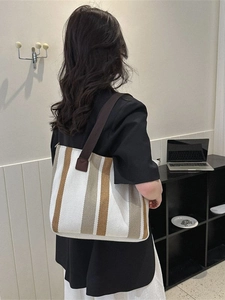 Vertical striped canvas tote bag for women showing spacious interior and casual shoulder style