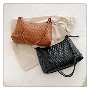 Detail of quilted diamond pattern and knotted shoulder straps on stylish bucket bags