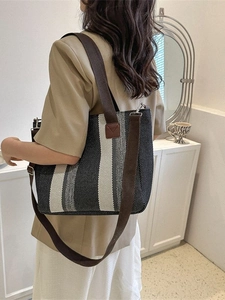 Minimalist canvas tote bag with black and white vertical stripes for women's daily use