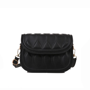 Classic black quilted crossbody bag with golden hardware and adjustable strap on white background