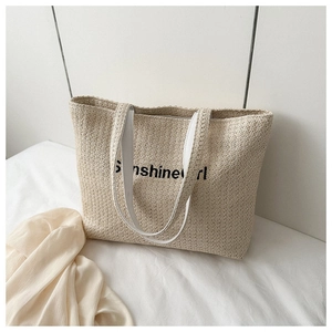 Close-up of woven canvas tote bag featuring Sunshinegirl text and white straps