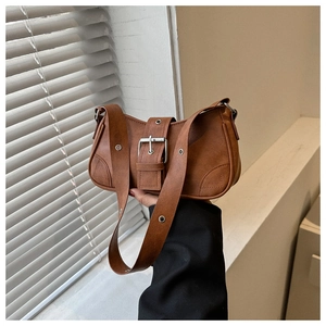 Close-up of the vintage brown faux leather square bag with silver metal eyelet strap