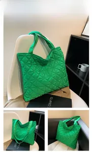 Detail of green quilted tote bag with diamond stitching in a lifestyle home setting