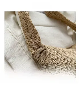 Macro shot of handcrafted straw bag showing herringbone weaving texture on natural fiber