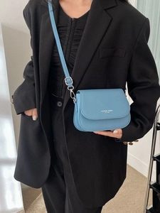 Blue faux leather crossbody flap bag with silver hardware and adjustable strap for women