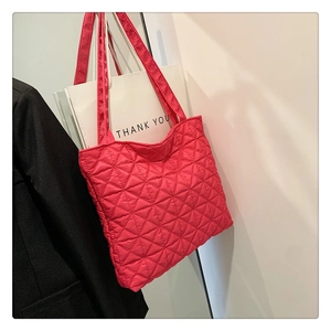 Detail of deep pink nylon tote bag featuring stylish triangular quilted stitching pattern