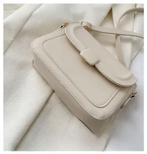 Detailed close-up showing the precise stitching and beige faux leather of the bag