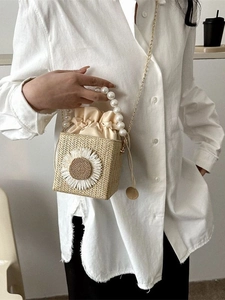 Straw woven square bucket bag with daisy applique, pearl handle, and gold chain strap