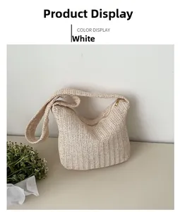 Detail of cream woven tote bag showing texture, wide shoulder strap and zip closure