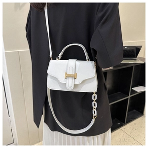 Detailed view of a white PU leather square bag featuring a gold buckle and dual straps