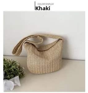 Detail of khaki straw tote bag with intricate herringbone weave and zipper closure