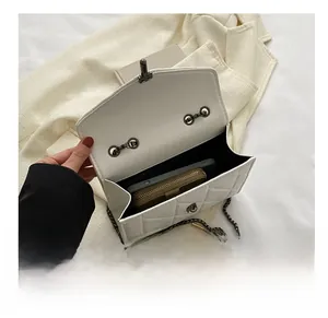 Vue détaillée de l'intérieur du sac matelassé blanc contenant téléphone et portefeuille