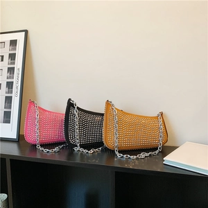 Studded half-moon shoulder bags with silver chain straps in rose, black, and yellow
