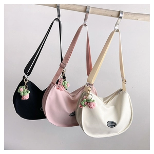 Three Oxford fabric hobo bags in black, pink, and white with cute strawberry charms