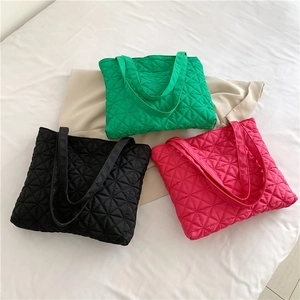 Chic quilted tote bag in star pattern, shown in green, black and pink colors