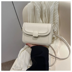 Detail of off-white minimalist leather handbag with square buckle and shoulder strap