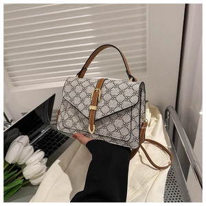 Detail of vintage square handbag with clover pattern and elegant leather handle