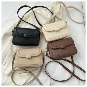 Flat lay of small crossbody square bags in black, beige, khaki, and brown faux leather