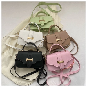 Collection of five stylish leather handbags with gold metal buckles and chain straps