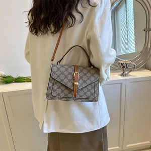 Retro taupe quilted crossbody bag with brown leather straps shown on a model