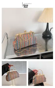 Detail of rose red woven chain bag with gold spherical clasp and round top handle