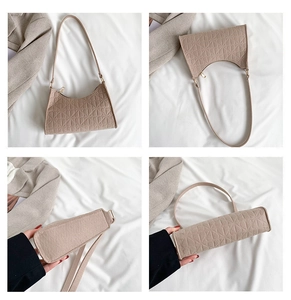 Detail view showing apricot geometric embossed pattern on a felt underarm shoulder bag