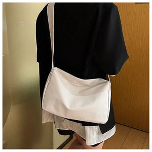 Minimalist white nylon crossbody bag worn by model showing casual style and matte finish