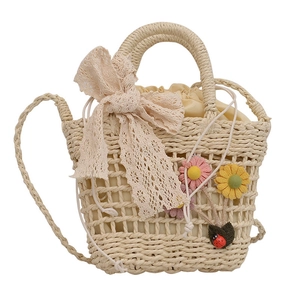 Handmade woven lace crossbody bag with floral accents and cream ribbon handles