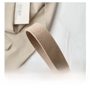 Detail of comfortable beige felt shoulder strap showing soft texture and premium stitching