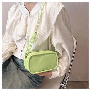 Detail of lime green leather bag with chain strap, showing fashion and bags embossing