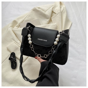 Detail of black leather and suede shoulder bag with pearl flower chain and fashion text