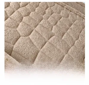 Macro shot of warm beige felt material with embossed crocodile pattern and gold stitching
