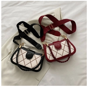 Close-up of quilted chain bags in black and wine red with dual functional straps